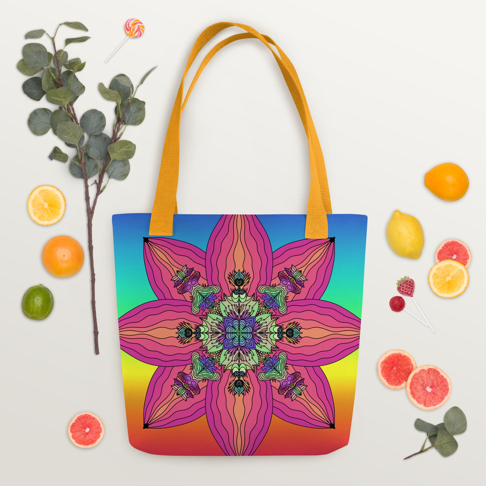 Blooming Kaleidoscope tote bag flat lay with orange slices and flowers