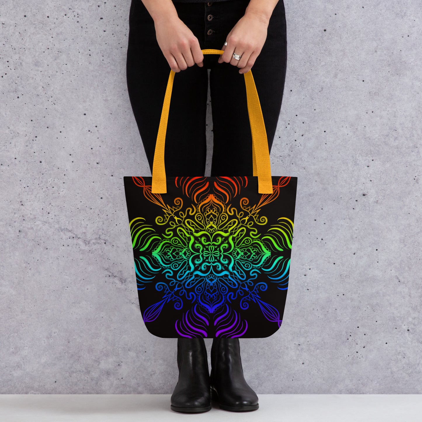 Woman holding the Elemental Harmony tote bag – colorful mandala print