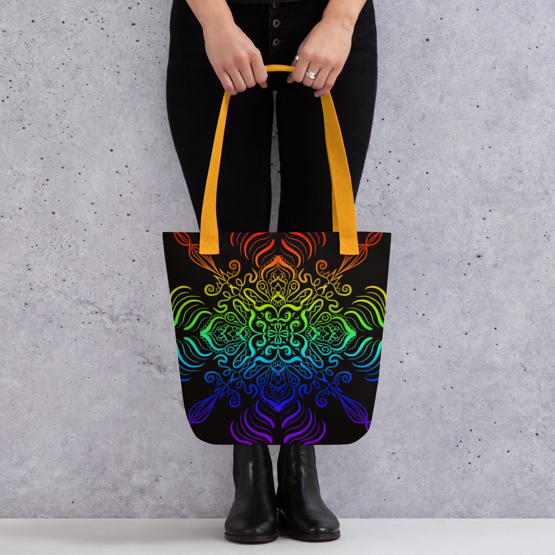 Woman holding the Elemental Harmony tote bag – colorful mandala print