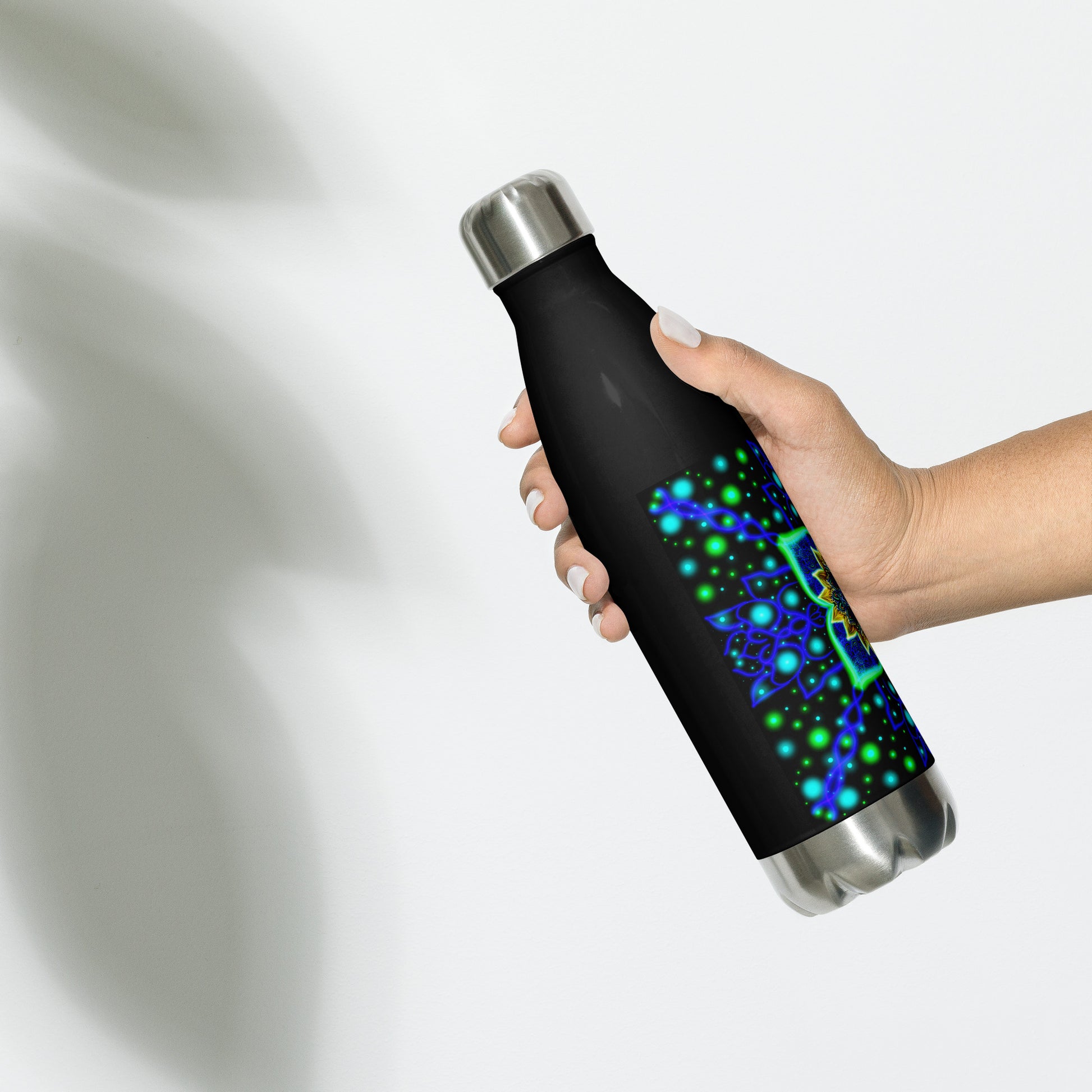 Hand holding the Quantum Pulse water bottle, showing sleek black finish and colorful mandala design